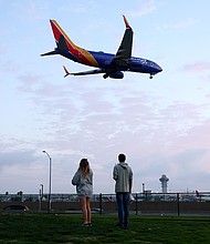 People view a Southwest Airlines plane landing from a park next to Los Angeles International Airport. For a limited time, Southwest Airlines is offering a promotional Companion Pass.
Mandatory Credit:	Mario Tama/Getty Images/File via CNN Newsource