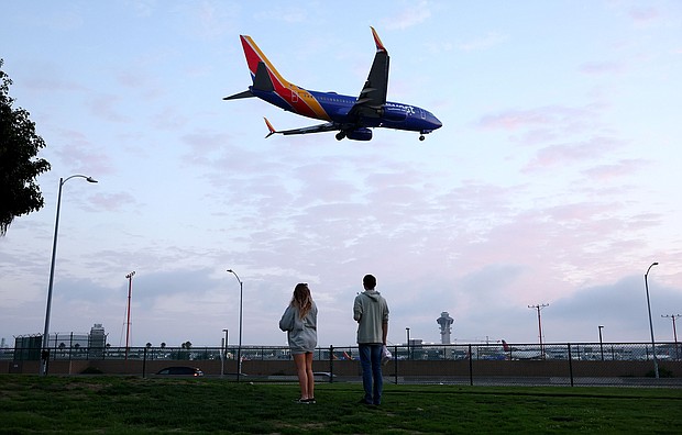 People view a Southwest Airlines plane landing from a park next to Los Angeles International Airport. For a limited time, Southwest Airlines is offering a promotional Companion Pass.
Mandatory Credit:	Mario Tama/Getty Images/File via CNN Newsource