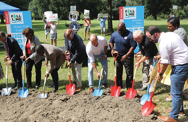 Richmond officials, including Mayor Levar M. Stoney, celebrate the Fall Line Trail groundbreaking Aug. 28 at Bryan Park, while protesters express opposition to the planned route through the historic park. The 43-mile trail will connect Ashland to Petersburg.