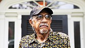 Ed Coleman, a Long COVID survivor, stands in front of the Henrico home he shares with his wife of 22 years, Charlene Warner Coleman.