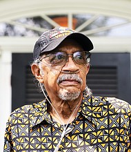 Ed Coleman, a Long COVID survivor, stands in front of the Henrico home he shares with his wife of 22 years, Charlene Warner Coleman.
