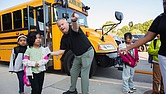 Students at Cardinal Elementary School are greeted by Assistant Principal Baylan Smith. The South Side school reopened this week after damage from a lightning strike on Aug. 26.