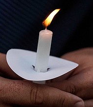Mark Gorman holds a candle during a vigil on September 4 for the slain students and teachers at Apalachee High School.
Mandatory Credit:	Mike Stewart/AP via CNN Newsource