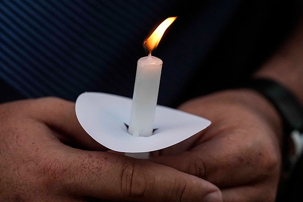 Mark Gorman holds a candle during a vigil on September 4 for the slain students and teachers at Apalachee High School.
Mandatory Credit:	Mike Stewart/AP via CNN Newsource