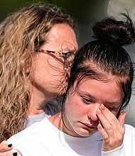 A student weeps at a makeshift memorial after a shooting Wednesday at Apalachee High School, on September 5, in Winder, Georgia.
Mandatory Credit:	Mike Stewart/AP via CNN Newsource
