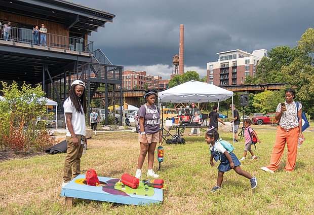 Vi’sjay Murphy, 3 , plays cornhole under the watchful eye of Mattia Pekanyande, Nala Jones, Miles Pekanyande and Zuri Arnold during the James River EcoFest Sept. 7 at the James A. Buzzard River Education Center.