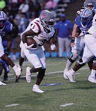 Virginia Union running back Jada Byers pushes through Hampton’s defense during a hard-fought game, where he rushed for 105 yards and two touchdowns.