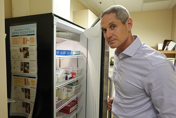 Childhood vaccines are stored in temperature-controlled refrigerators at Dr. Eric Ball’s practice in Orange County, Calif.