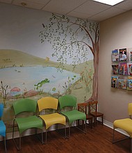 Murals adorn the walls of the waiting room at Dr. Ball’s pediatrics practice.