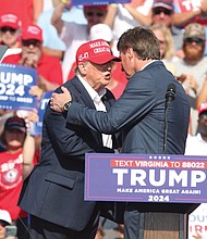 Former President Donald Trump shakes hands with Virginia Gov. Glenn Youngkin at a rally in Chesapeake, June 28, 2024.