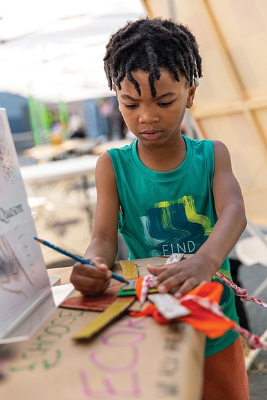 Joseph decorates a mask he made during ART 180’s Block Party on May 3.