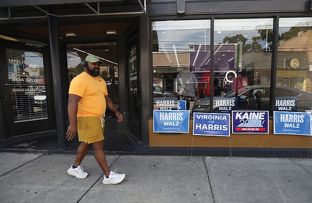 Signs of the times at Unlimited Performance Barber Shop in North Side on Aug. 24.