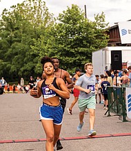 Kacie Boone crosses the finish line of the Belle Isle Blitze 5K trail race during the 16th Annual Dominion Riverrock on May 17.