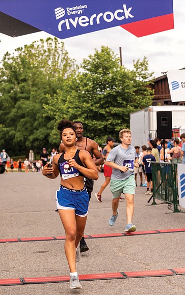 Kacie Boone crosses the finish line of the Belle Isle Blitze 5K trail race during the 16th Annual Dominion Riverrock on May 17.