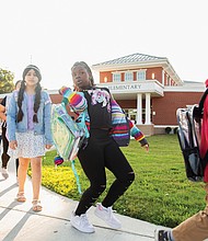 Children arrive at the newly reopened Cardinal Elementary school on Sept. 3.