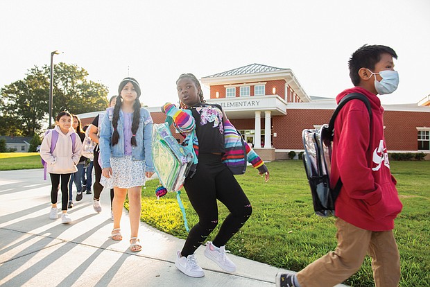 Children arrive at the newly reopened Cardinal Elementary school on Sept. 3.
