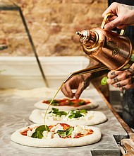 The olive oil – and the praise – flows Una Pizza Napoletana in New York City.
Mandatory Credit:	Mark Weinberg via CNN Newsource