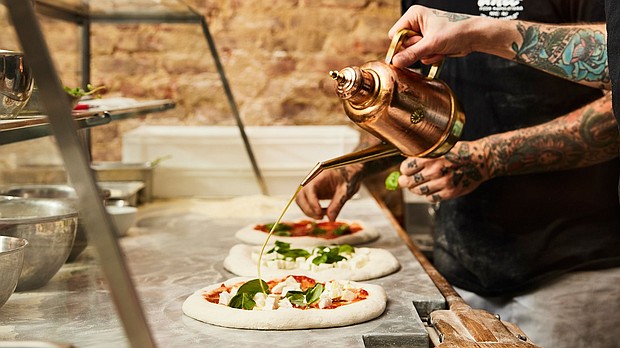 The olive oil – and the praise – flows Una Pizza Napoletana in New York City.
Mandatory Credit:	Mark Weinberg via CNN Newsource