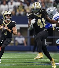 Carr threw 11-of-16 for 243 yards, two touchdowns and an interception against the Cowboys.
Mandatory Credit:	Jeffrey McWhorter/AP via CNN Newsource