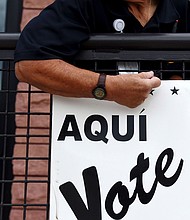 A Bexar County employee sets up signs during early voting at a polling location in San Antonio, Texas during October 2018.
Mandatory Credit:	Callaghan O'Hare/Bloomberg/Getty Images via CNN Newsource