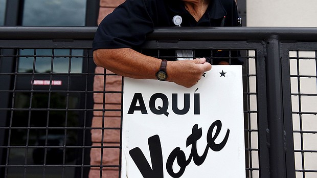 A Bexar County employee sets up signs during early voting at a polling location in San Antonio, Texas during October 2018.
Mandatory Credit:	Callaghan O'Hare/Bloomberg/Getty Images via CNN Newsource