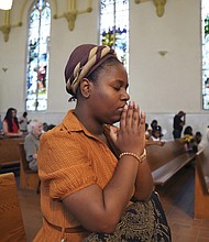 Marie Morette, a congregant at St. Raphael Catholic Church, prays Sunday during Mass in Springfield, Ohio.
