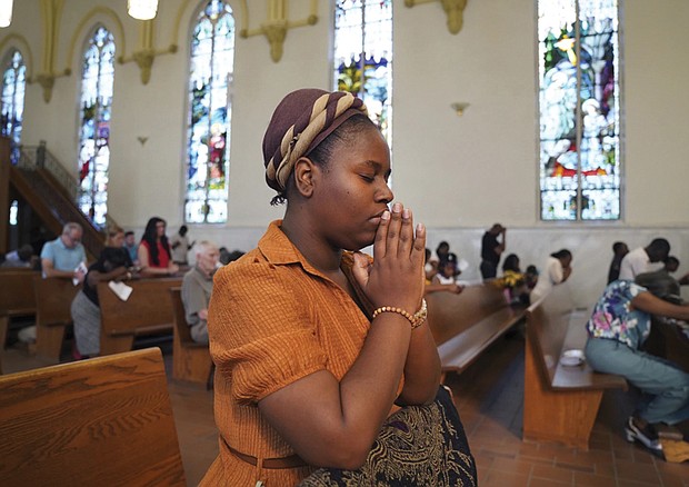 Marie Morette, a congregant at St. Raphael Catholic Church, prays Sunday during Mass in Springfield, Ohio.