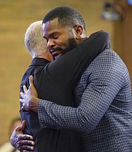 Carl Ruby, pastor at Central Christian Church, hugs Lindsay Aime during a Sunday service on Sept. 15, in Springfield, Ohio.