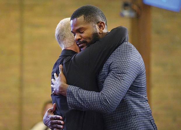 Carl Ruby, pastor at Central Christian Church, hugs Lindsay Aime during a Sunday service on Sept. 15, in Springfield, Ohio.