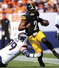 Pittsburgh Steelers quarterback Justin Fields (2) runs against Denver Broncos defensive end Zach Allen (99) on Sunday, Sept. 15, in Denver.