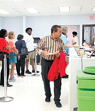 Voters line up at the Richmond Office of Elections on Sept. 20 to cast their ballots for early in-person voting in the 2024 presidential election, along with U.S. Senate, congressional, mayoral, City Council and School Board races. The office is located at 2134 W. Laburnum Ave.