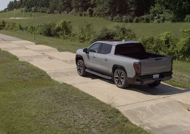 The 2024 GMC Sierra EV undergoes truck obstacle during development testing at General Motors’ Milford Proving Ground.