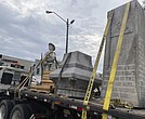 Pieces of a Confederate monument are secured onto a flatbed truck Wednesday, Sept. 11, after a crew removed them from the spot where the monument had stood since 1910, in downtown Grenada, Miss.