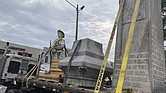 Pieces of a Confederate monument are secured onto a flatbed truck Wednesday, Sept. 11, after a crew removed them from the spot where the monument had stood since 1910, in downtown Grenada, Miss.