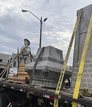 Pieces of a Confederate monument are secured onto a flatbed truck Wednesday, Sept. 11, after a crew removed them from the spot where the monument had stood since 1910, in downtown Grenada, Miss.