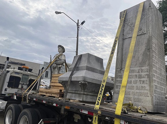 A Confederate monument that was removed from a courthouse square in Mississippi will remain in storage rather than being put …