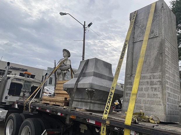 Pieces of a Confederate monument are secured onto a flatbed truck Wednesday, Sept. 11, after a crew removed them from the spot where the monument had stood since 1910, in downtown Grenada, Miss.