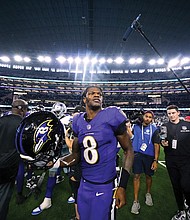 Baltimore Ravens quarterback Lamar Jackson (8) walks off the field Sunday after the team’s win over the
Dallas Cowboys in Arlington, Texas.