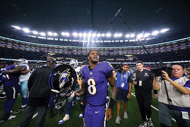 Baltimore Ravens quarterback Lamar Jackson (8) walks off the field Sunday after the team’s win over the
Dallas Cowboys in Arlington, Texas.