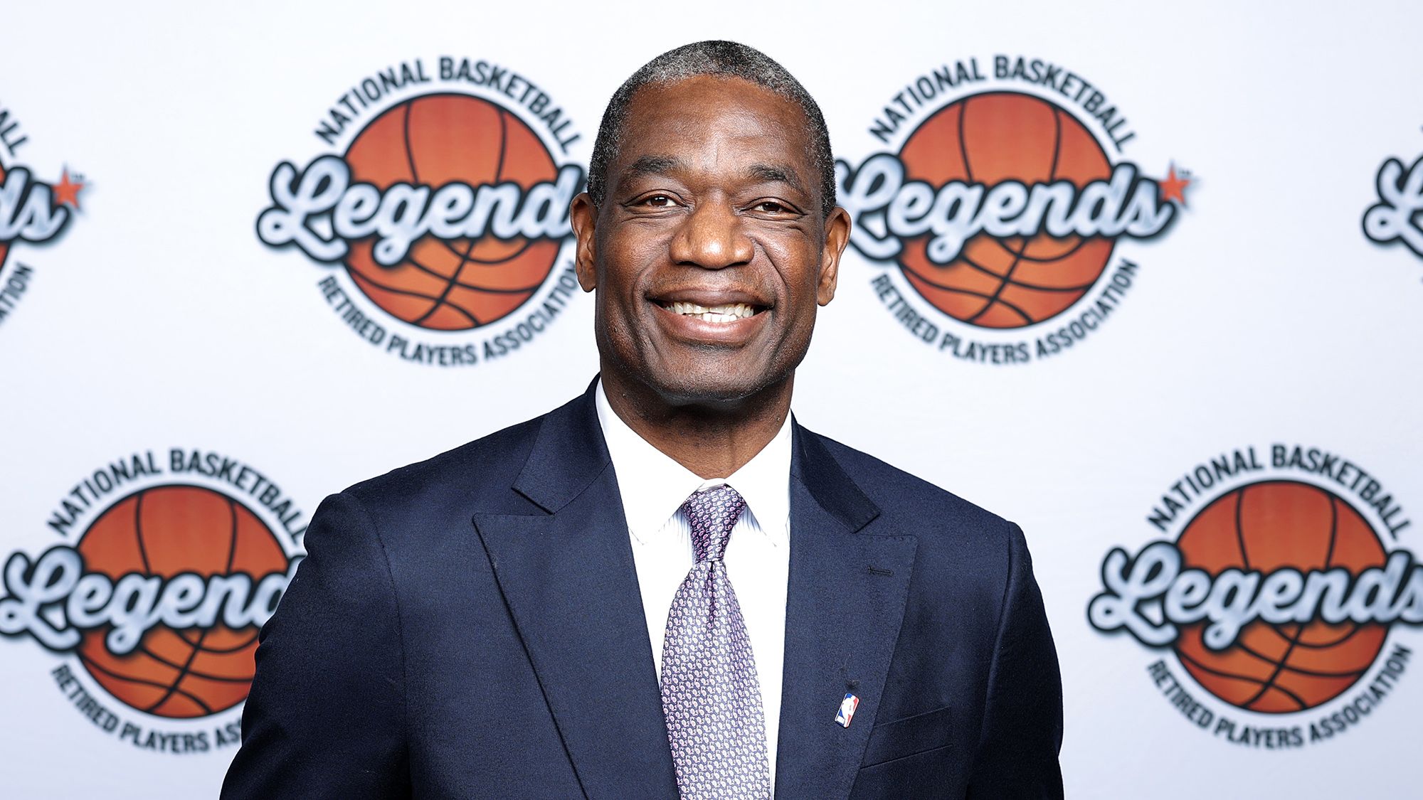 Basketball star Dikembe Mutombo, known for his shot-blocking skill and