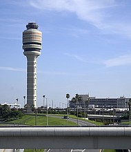 The FAA air traffic control tower is pictured at Orlando International Airport. The Federal Aviation Administration says that graduates of two college air traffic control programs can now bypass the agency’s backlogged training academy.
Mandatory Credit:	Phelan M. Ebenhack/AP via CNN Newsource