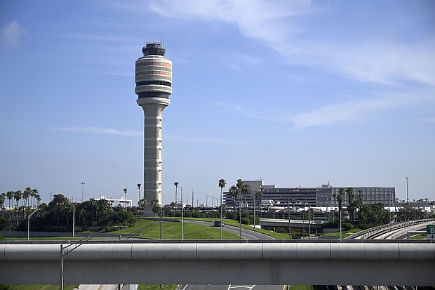 The FAA air traffic control tower is pictured at Orlando International Airport. The Federal Aviation Administration says that graduates of two college air traffic control programs can now bypass the agency’s backlogged training academy.
Mandatory Credit:	Phelan M. Ebenhack/AP via CNN Newsource