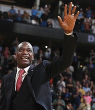Retired Denver Nuggets center Dikembe Mutombo waves to the crowd as his jersey number is retired by the team during halftime of the Nuggets’ basketball game against the Portland Trail Blazers on Oct. 29, 2016, in Denver.