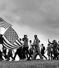 “The March to Selma,” shot by Matt Heron, captures a pivotal moment from the Civil Rights Movement, documenting the historic 1965 Selma to Montgomery marches. It is featured in “A Long Arc: Photography and the American South since 1845,” at the Virginia Museum of Fine Arts (VMFA).