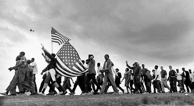 “The March to Selma,” shot by Matt Heron, captures a pivotal moment from the Civil Rights Movement, documenting the historic 1965 Selma to Montgomery marches. It is featured in “A Long Arc: Photography and the American South since 1845,” at the Virginia Museum of Fine Arts (VMFA).