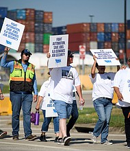 Striking workers hold up signs and march in front of the Bayport Container Terminal in Seabrook, Texas, on October 3. The International Longshoremen's Association (ILA), 85,000 members strong, has launched its first strike since 1977 after weeks of deadlocked negotiations over a six-year labor agreement.
Mandatory Credit:	Mark Felix/AFP/Getty Images via CNN Newsource
