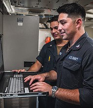 Electronics Technician 3rd Class Mateo Martinez, right, from Los Alamos, New Mexico, and Electronics Technician 3rd Class William Mazariegos, from Houston, both assigned to combat systems department’s exterior communications division, troubleshoot a computer aboard Nimitz-class aircraft carrier USS George Washington (CVN 73) while underway in the Pacific Ocean, Oct. 2, 2024. As an integral part of U.S. Pacific Fleet, U.S. 3rd Fleet operates naval forces in the Indo-Pacific in addition to providing realistic and relevant training necessary to flawlessly execute our Navy’s timeless roles of sea control and power projection. U.S. 3rd Fleet works in close coordination with other numbered fleets to provide commanders with capable, ready forces to deploy forward and win in day-to-day competition, in crisis, and in conflict. (U.S. Navy photo by Mass Communication Specialist 3rd Class Wadelon Presley)