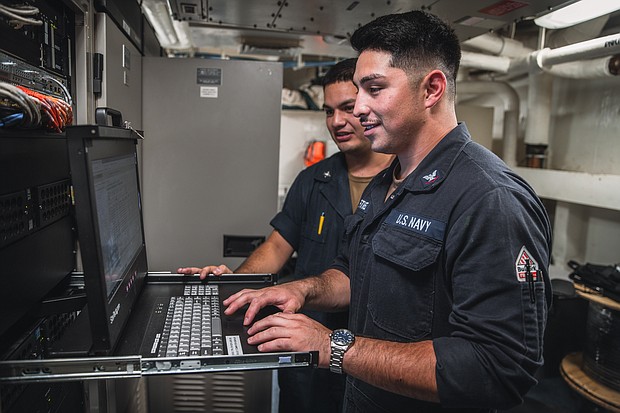 Electronics Technician 3rd Class Mateo Martinez, right, from Los Alamos, New Mexico, and Electronics Technician 3rd Class William Mazariegos, from Houston, both assigned to combat systems department’s exterior communications division, troubleshoot a computer aboard Nimitz-class aircraft carrier USS George Washington (CVN 73) while underway in the Pacific Ocean, Oct. 2, 2024. As an integral part of U.S. Pacific Fleet, U.S. 3rd Fleet operates naval forces in the Indo-Pacific in addition to providing realistic and relevant training necessary to flawlessly execute our Navy’s timeless roles of sea control and power projection. U.S. 3rd Fleet works in close coordination with other numbered fleets to provide commanders with capable, ready forces to deploy forward and win in day-to-day competition, in crisis, and in conflict. (U.S. Navy photo by Mass Communication Specialist 3rd Class Wadelon Presley)