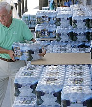 Larry Pierson purchases bottled water from the Harris Teeter grocery store on the Isle of Palms in preparation for Hurricane Florence in September 2018.
Mandatory Credit:	Mic Smith/AP via CNN Newsource