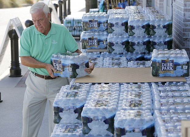 Larry Pierson purchases bottled water from the Harris Teeter grocery store on the Isle of Palms in preparation for Hurricane Florence in September 2018.
Mandatory Credit:	Mic Smith/AP via CNN Newsource